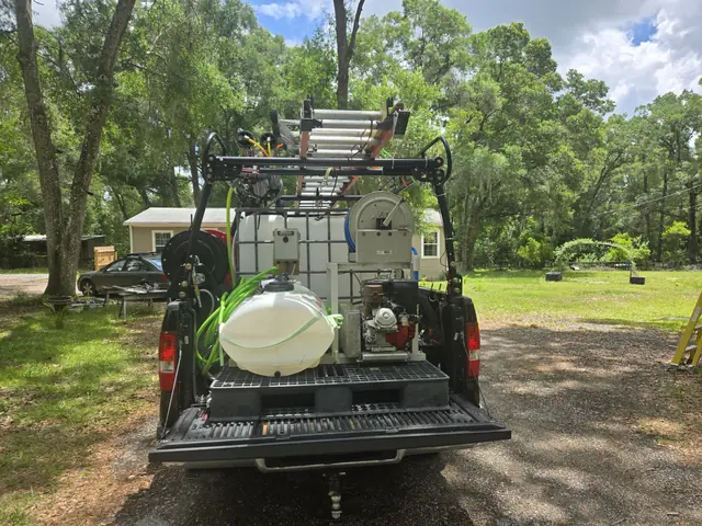 Truck bed rig with water tank, pump and hose reels