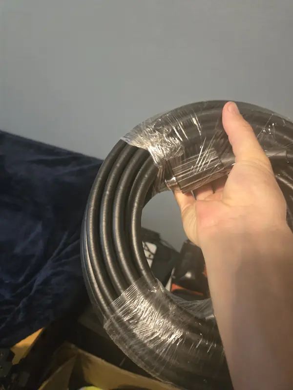 Coiled high-pressure hose held in hand
