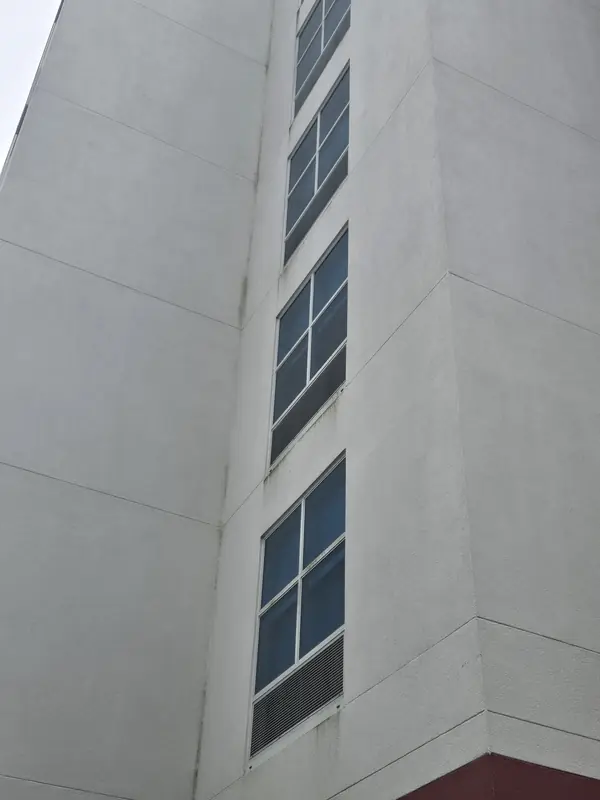 Close view of streaks and staining on a white hotel façade