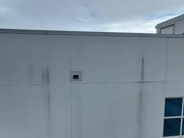 Aerial close-up of a stained upper wall on the hotel