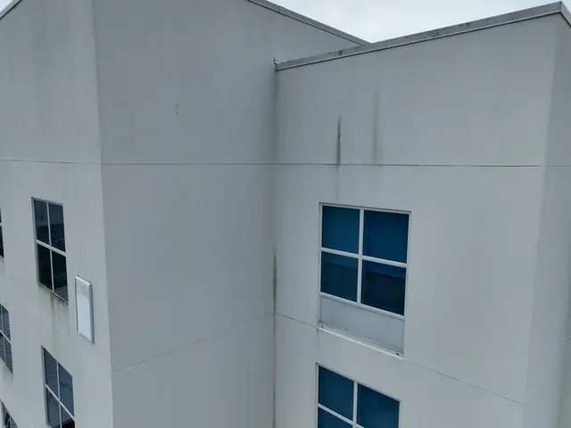 Aerial view of hotel wall sections with dark staining