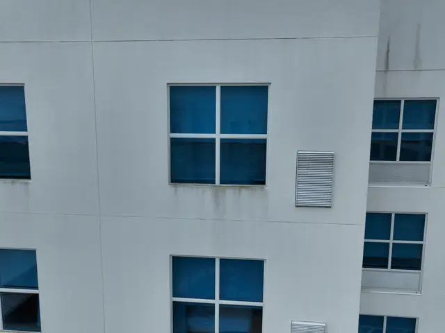Aerial view of upper-floor hotel walls and windows before cleaning