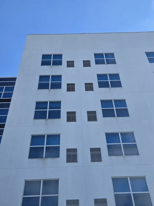 Clean upper floors of the hotel against a blue sky