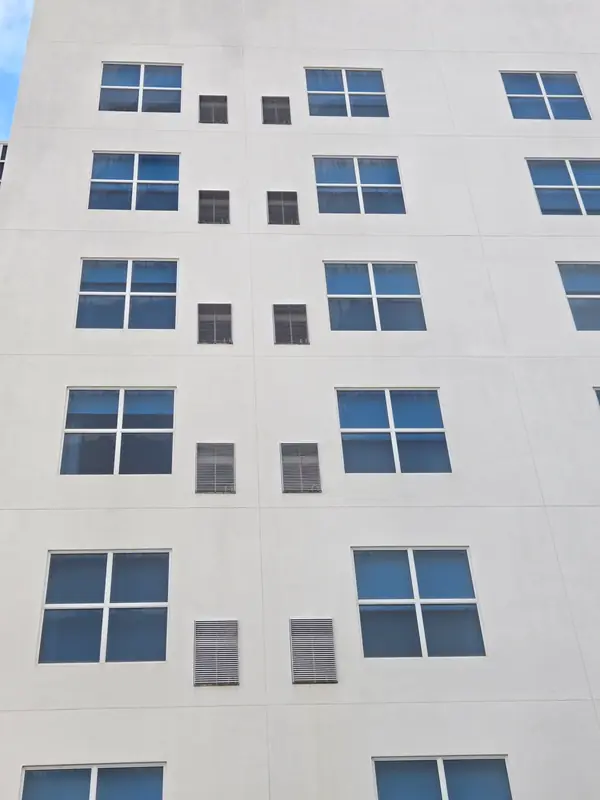View looking up the clean white hotel façade