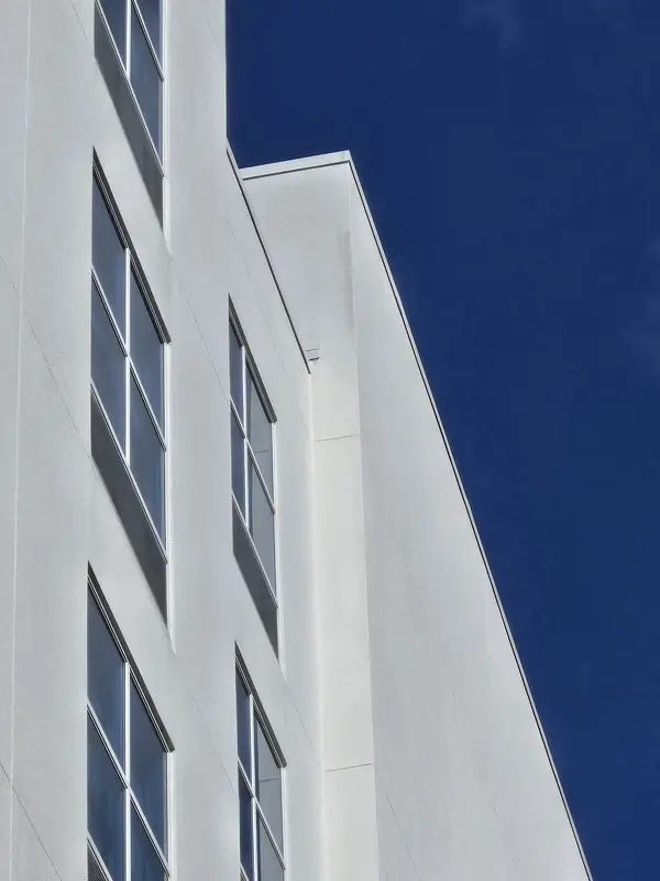 Clean hotel wall and windows against a deep blue sky