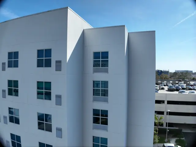 Aerial view of the hotel wings and parking area