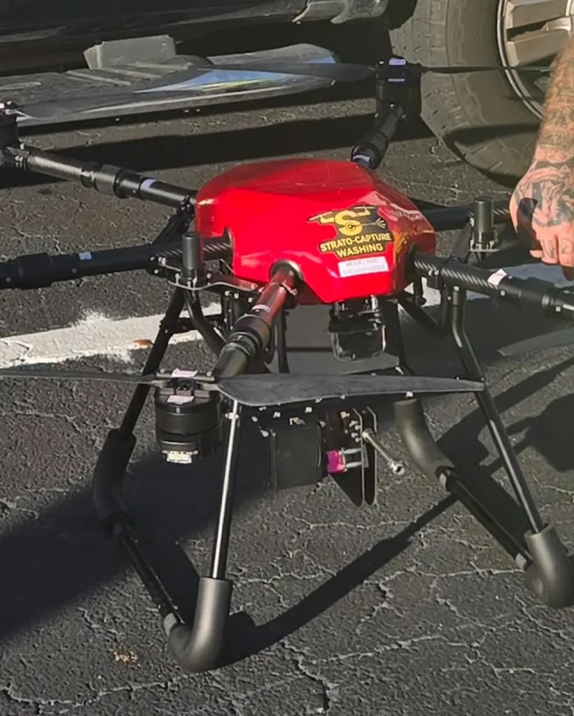 Red Strato-Capture Washing cleaning drone being prepared on a job site