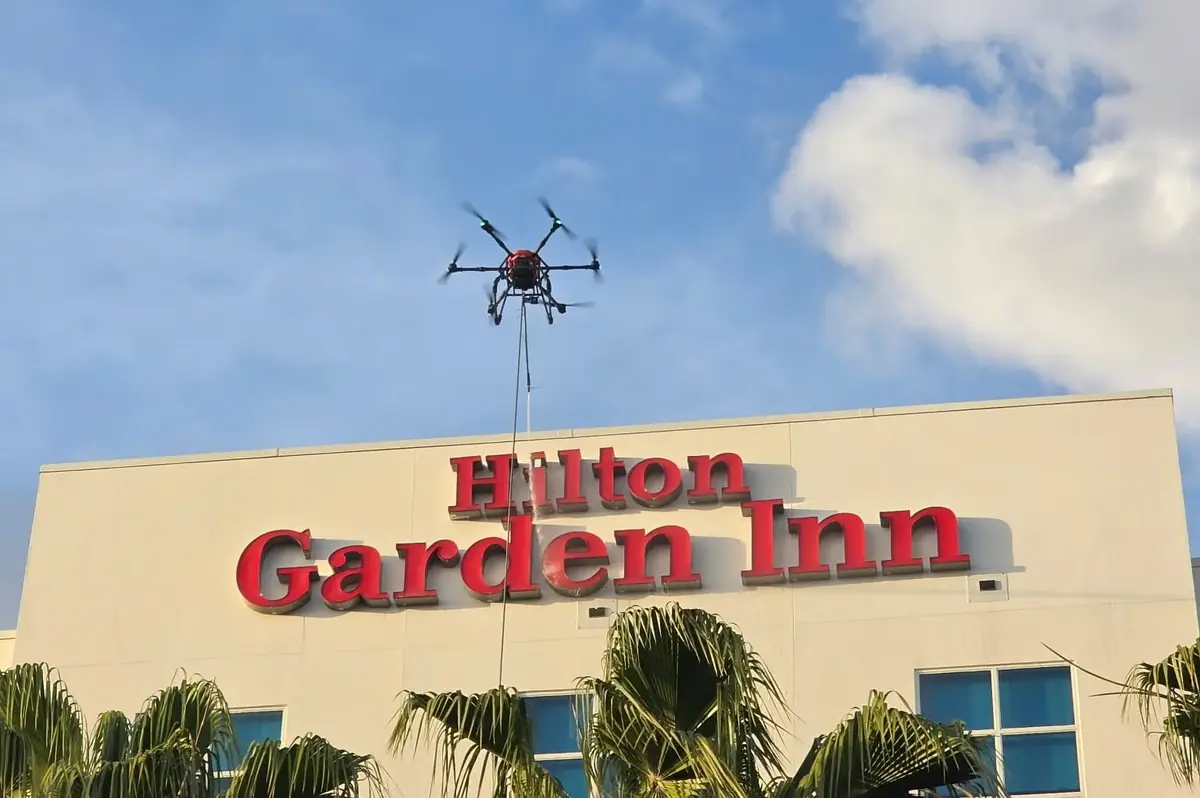 Cleaning drone working on a Hilton Garden Inn hotel exterior